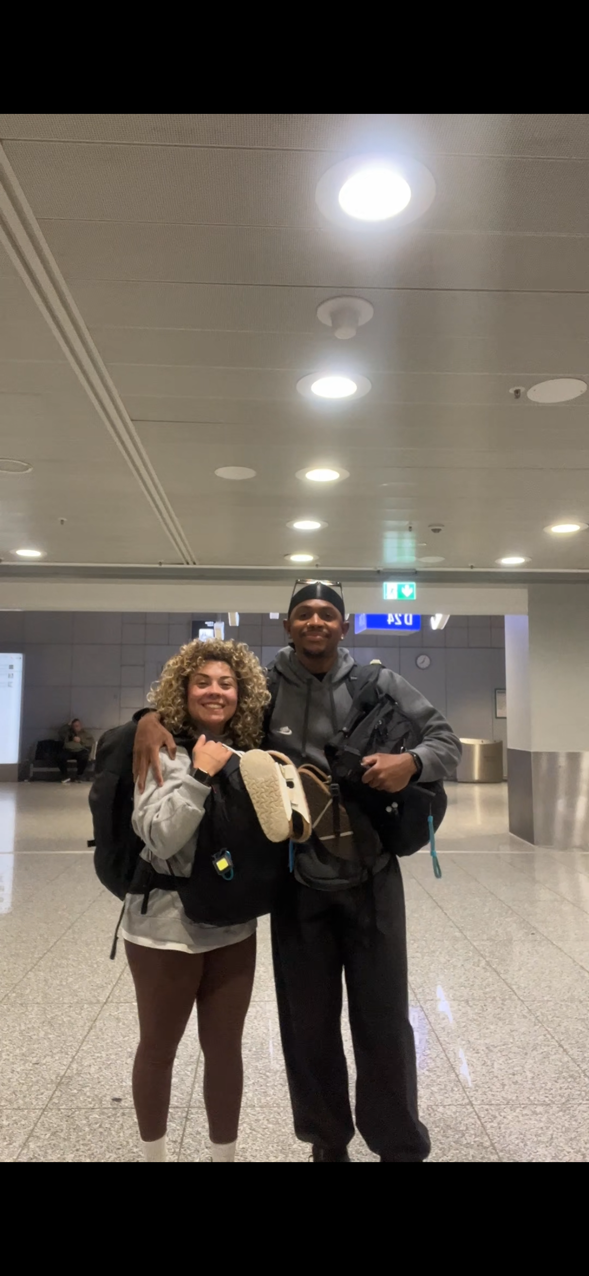 Jay and Fabienne with their backpacks at the airport